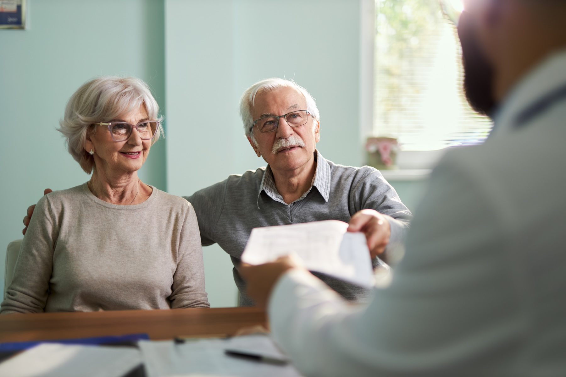 Retired couple talking insurance.